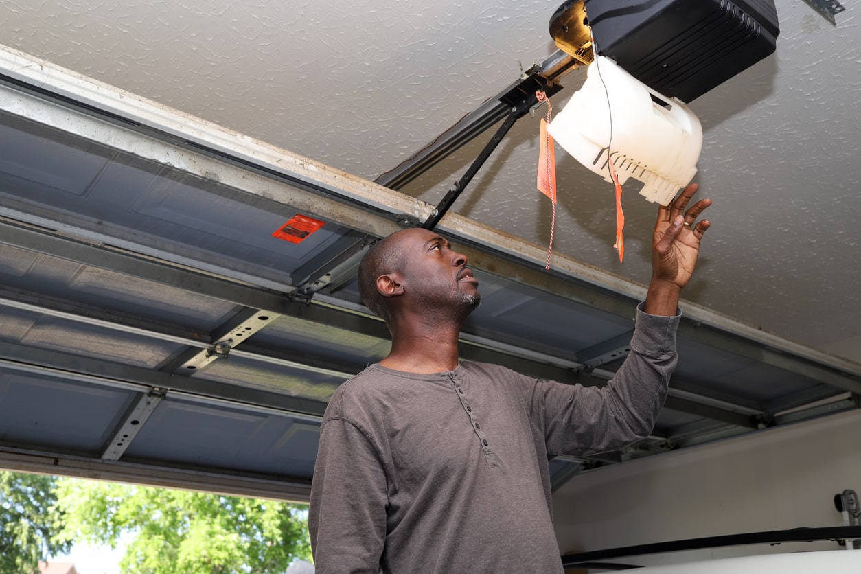 Technician inspecting a garage door opener
